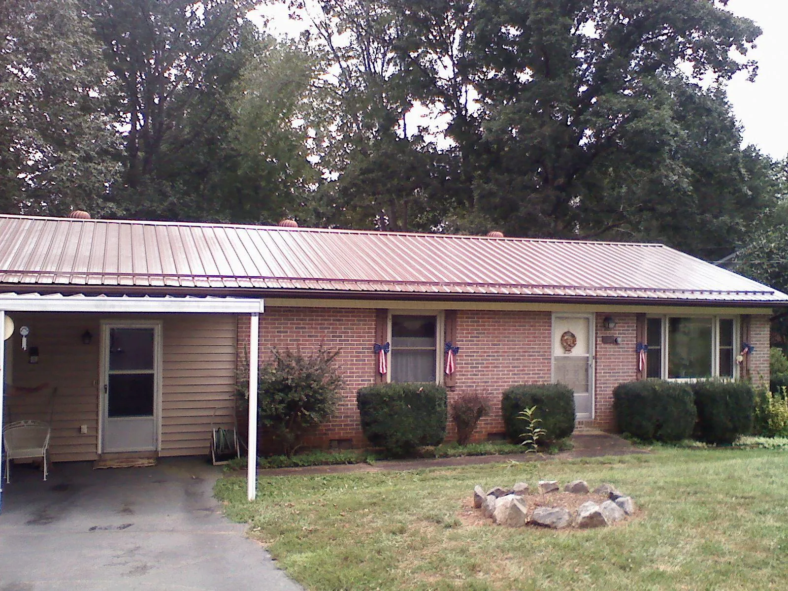 Bronze metal roof and carport on a brick ranch home — Roof Repair work by our crew in Wrightstown