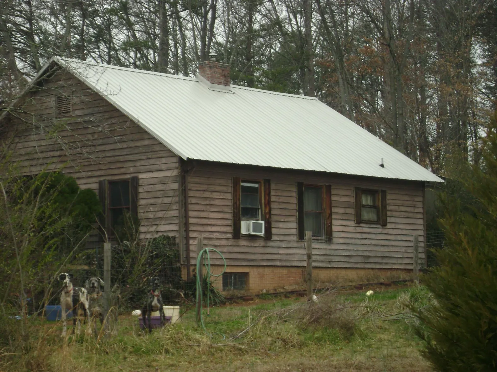 White metal roof on an old wood sided farmhouse, from a Metal Roof Installation job in Wrightstown